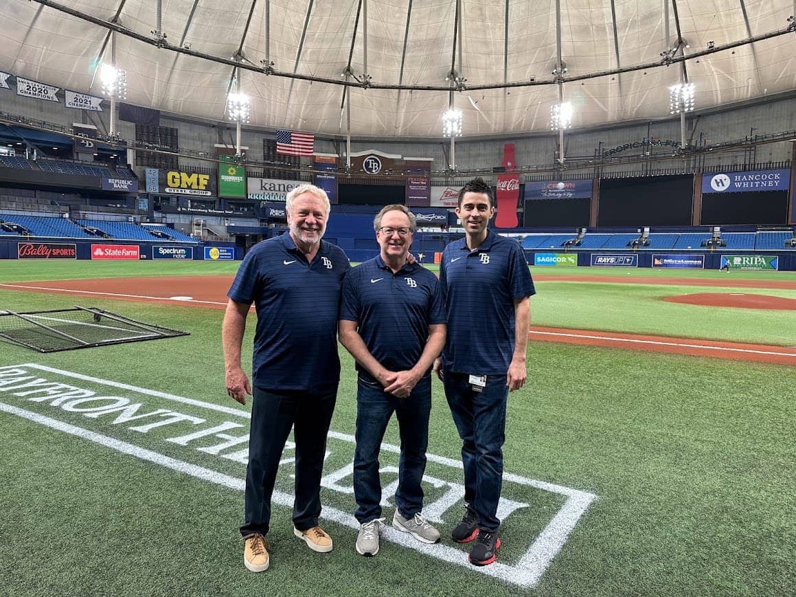 Dr. Levy, Dr. Zusman and Dr. Solano standing on the field at Tropicana Field